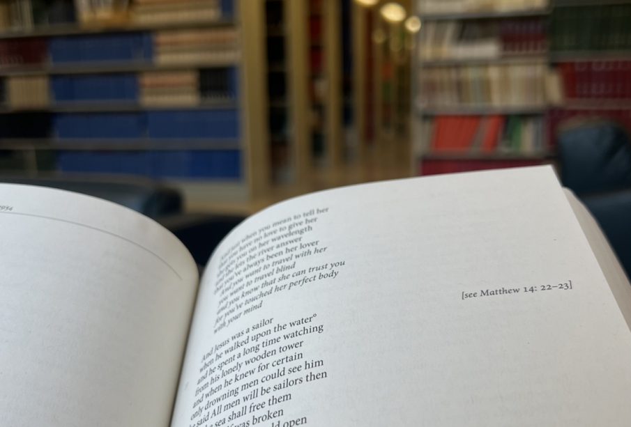 A book is open to Leonard Cohen’s “Suzanne”