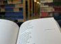 A book is open to Leonard Cohen’s “Suzanne”