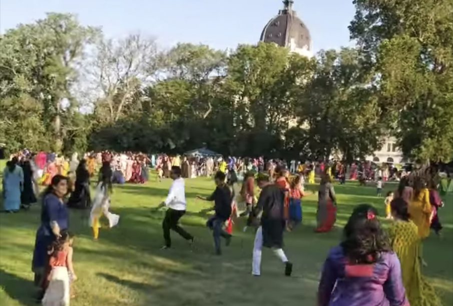 Participants of the Garba-Ras event dance on the greens in front of the Legislative Building.