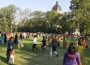Participants of the Garba-Ras event dance on the greens in front of the Legislative Building.