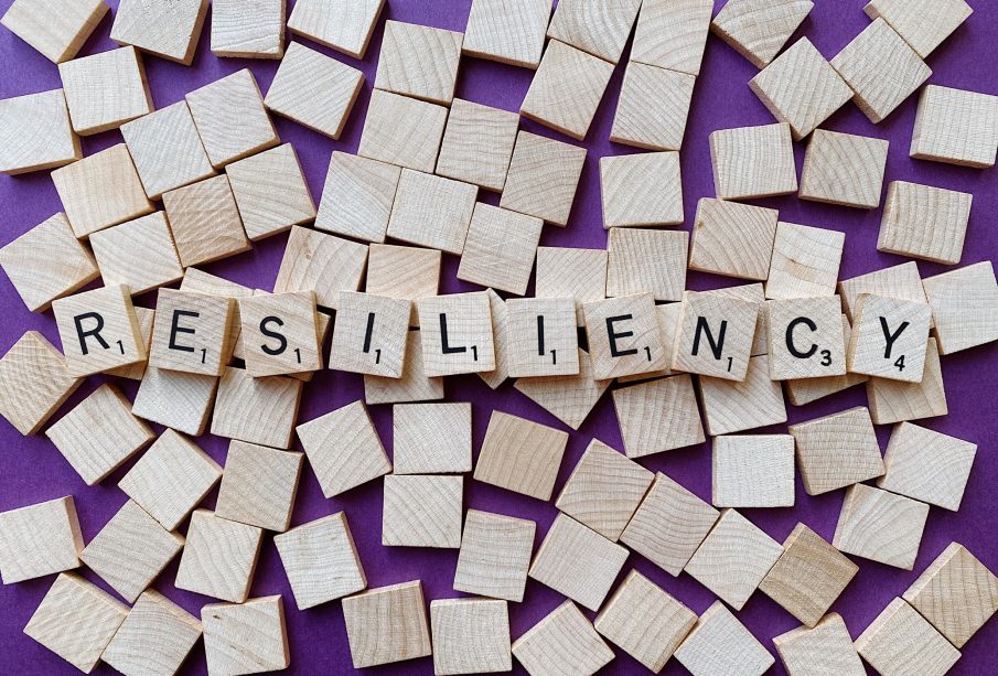 Scrabble letters spread out to form the word “resiliency”