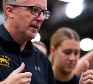 Cougars women’s basketball head coach Dave Taylor stands strategizing with and encouraging the team.