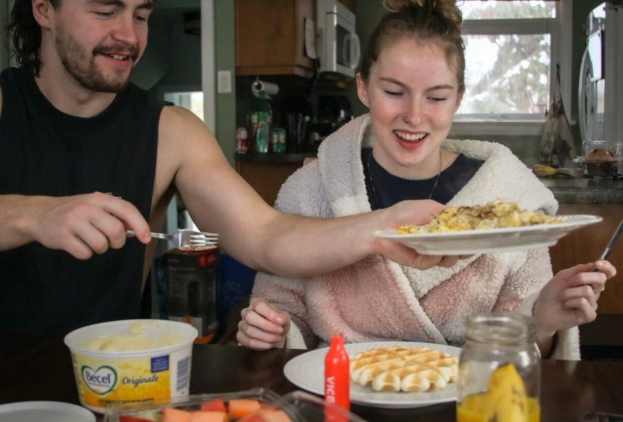Madi Reynolds (right) sits down to enjoy the meal she has prepared for her best friends on a snowy Sunday in January when they travelled to visit her.