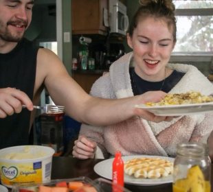 Madi Reynolds (right) sits down to enjoy the meal she has prepared for her best friends on a snowy Sunday in January when they travelled to visit her.