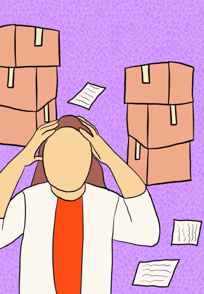 A person with both hands on their head, with some papers strewn around the floor and boxes in the background.