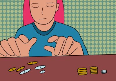 A person sitting at a desk counting change.