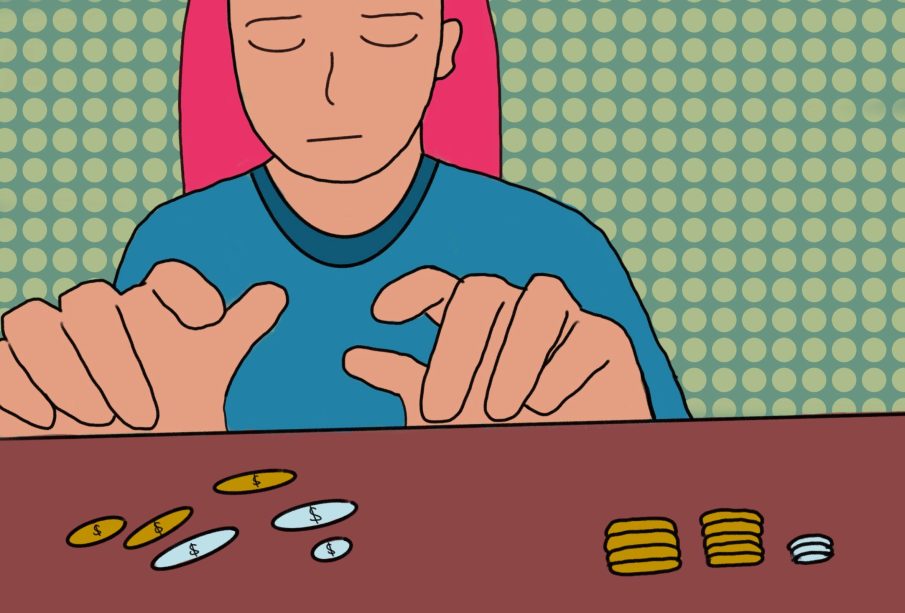 A person sitting at a desk counting change.