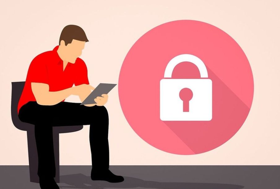 A person works on their iPad with difficulty as a large lock sits on the screen.