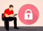 A person works on their iPad with difficulty as a large lock sits on the screen.