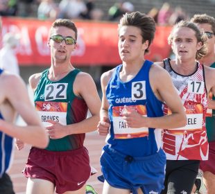 A group of runners in a marathon round a corner, gasping for breath as they push through exhaustion.