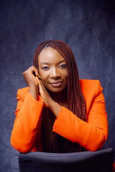 A profile shot of Shakirat Edoho, wearing an orange jacket.