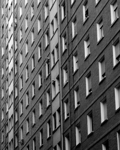 A bleak grey apartment complex with a high density of living units.