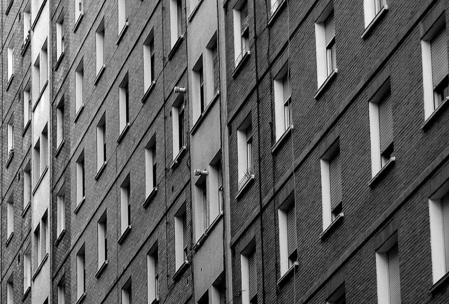 A bleak grey apartment complex with a high density of living units.
