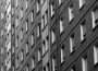 A bleak grey apartment complex with a high density of living units.