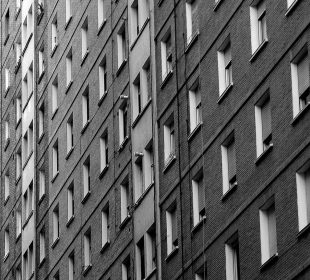 A bleak grey apartment complex with a high density of living units.