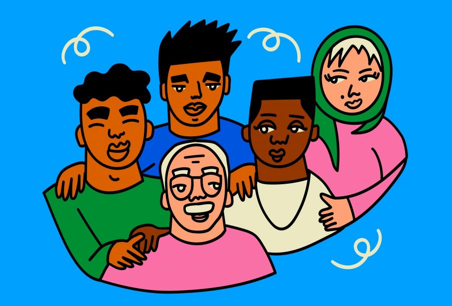 A group of people of diverse ethnic background, ages, and genders all standing together in a big hug.
