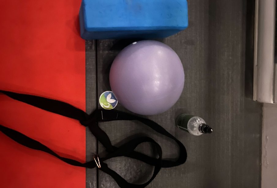 A photo of straps, an exercise ball and a yoga mat.