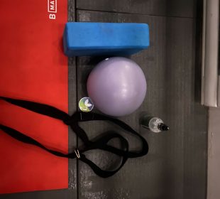 A photo of straps, an exercise ball and a yoga mat.