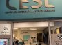 A door opens into an office space with the words “Centre for Experiential and Service Learning” overhead.