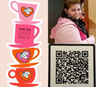 There is a stack of tea cups and plates beside an image of a person. On the left side there are four pink and orange tea cups stacked with their tea plates between them. There are triple leaf designs on three of the tea cups, while the second from the top has “This Tea Gives Back” written on it. The person to the write of the image is wearing black leggings, a light pink sweater, and a hot pink shirt along with a black purse and a black and white patterned scarf. They are smiling to the left of the camera and grabbing a water from a shelf that is behind their head and to their left.