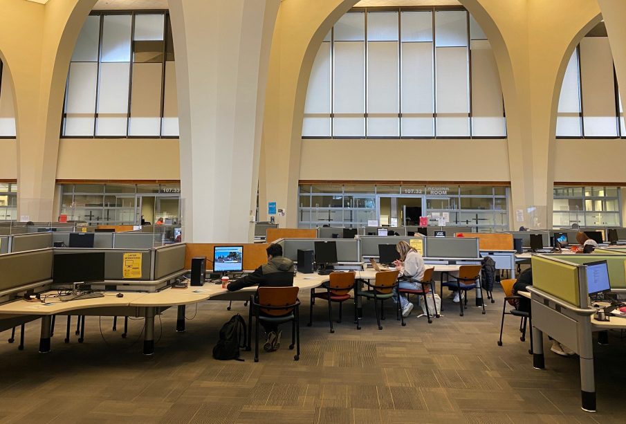The ground floor of the Archer library, from the entrance. Students are studying at some of the computers.