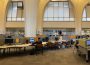 The ground floor of the Archer library, from the entrance. Students are studying at some of the computers.