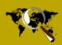 An image of the world map on a yellow background and with a giant magnifying glass over the middle of the map.