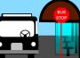 Looking at the front of a city bus stopped at a glass-enclosed bus stop with a red sign with white text spelling “Bus Stop.”