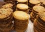 Many stacks of cookies that look like they contain nuts and chocolate chips.
