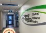 A photo of a wall with the words “University of Regina Student Wellness Centre” on it. 