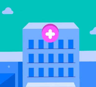 A blue hospital with a pink and white emergency cross sign above the entrance with a teal sky in the background.