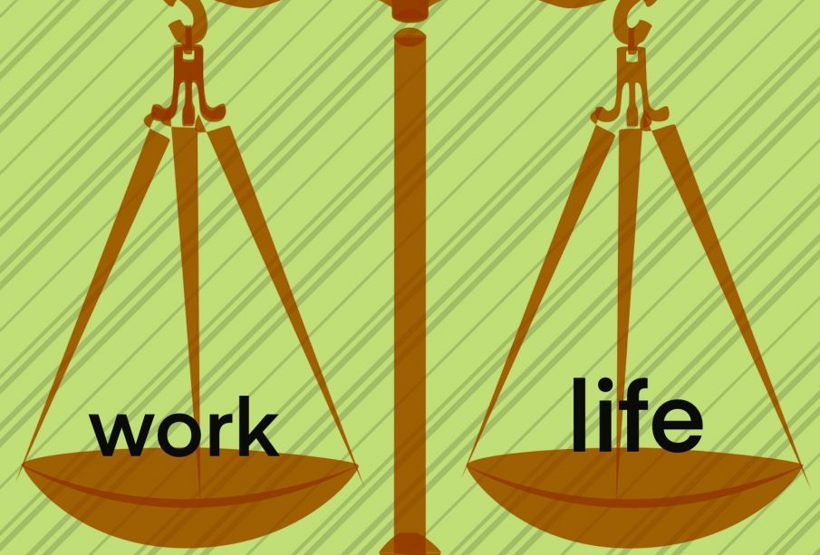 A balanced balance scale with “work” and “life” on the scales.
