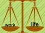 A balanced balance scale with “work” and “life” on the scales.