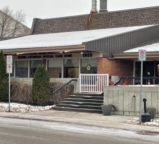 A photo of Regina Lutheran Home’s front entrance from the sidewalk across from the building. 