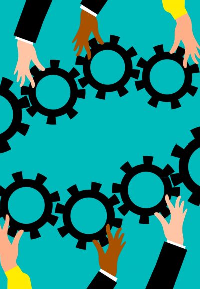 Several different hands juggle and fit together gears like those found in clockworks.