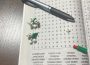 A word search with a two small white Lego flowers and one large Lego flower.
