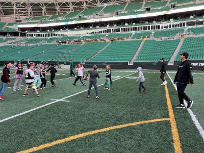 Two Ehrlo Sport Venture youth football teams playing in Mosaic Stadium.