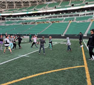 Two Ehrlo Sport Venture youth football teams playing in Mosaic Stadium.