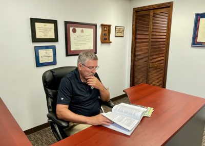 Rod Buckingham sitting at his desk in his Regina office