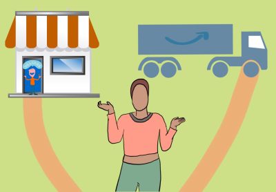 A person standing at a fork in a road, with one road going to a small local store and the other toward an Amazon delivery truck.