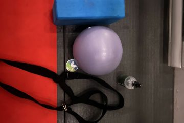 A photo of straps, an exercise ball and a yoga mat.