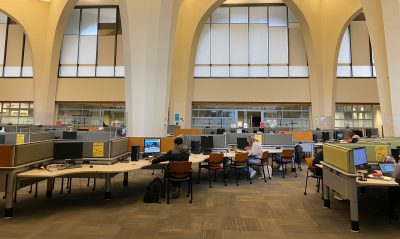 The ground floor of the Archer library, from the entrance. Students are studying at some of the computers.