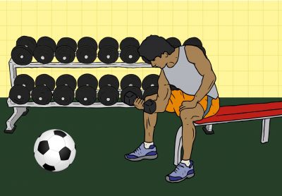 A young person doing curls with a dumbbell while a soccer ball rests in front of them.